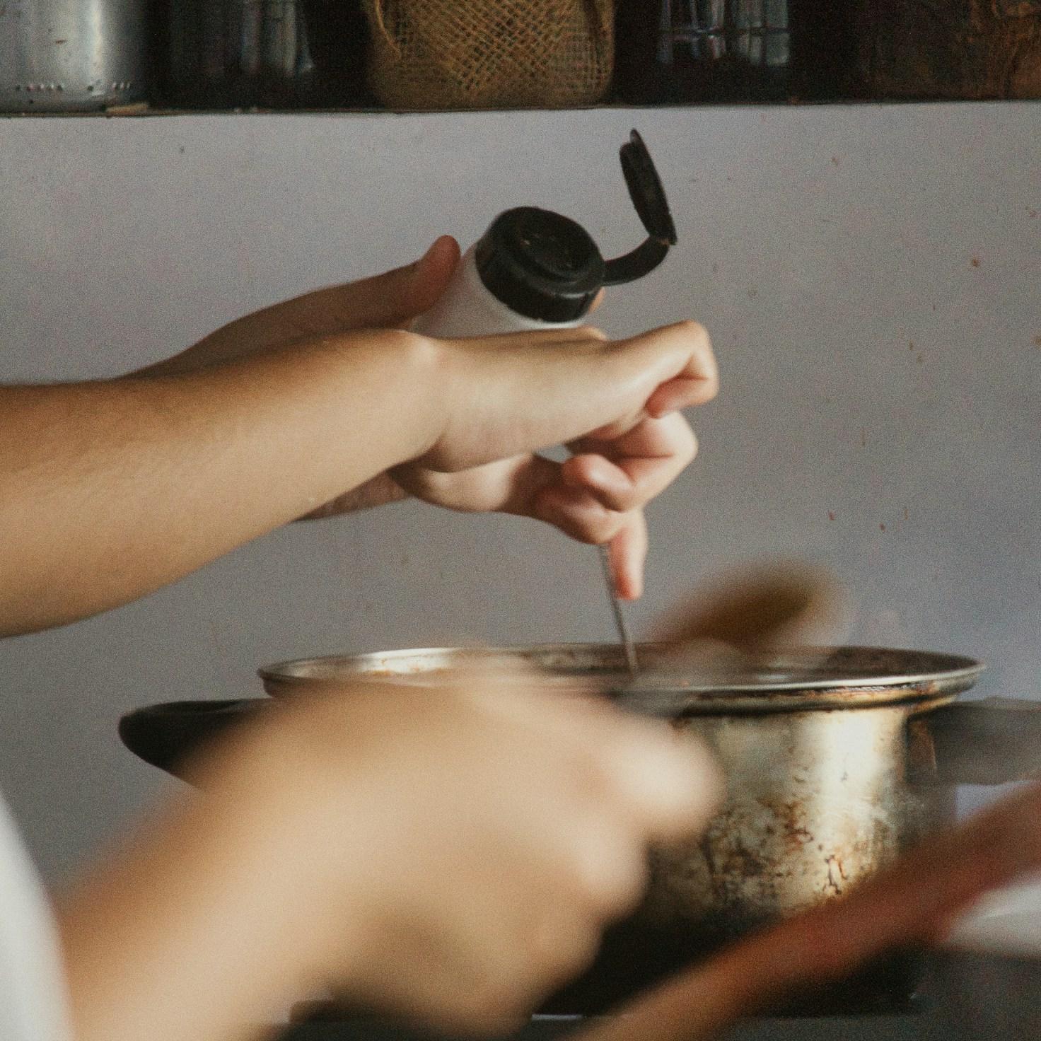 Community members collaborating in a modern kitchen space, sharing recipes and cooking techniques